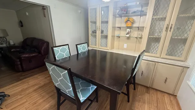 a view of a dining room with furniture and wooden floor