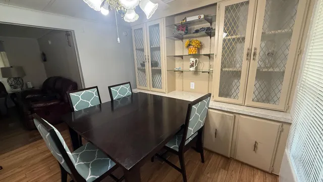 a view of a dining room with furniture window and wooden floor