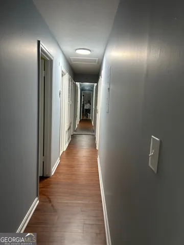 a view of hallway with wooden floor