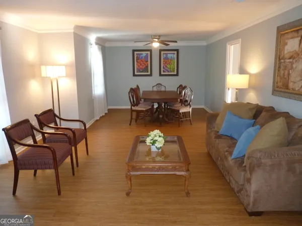 a living room with furniture and a lamps