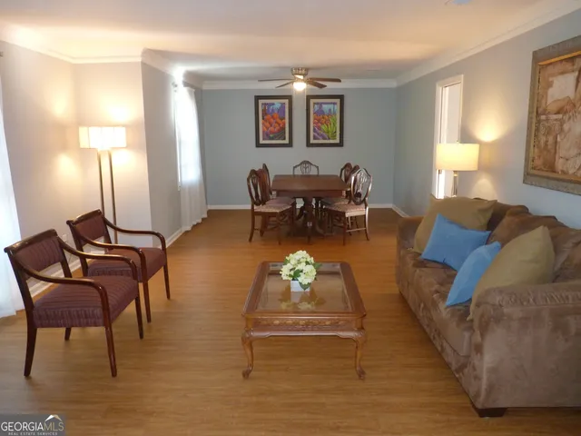 a living room with furniture and a lamps