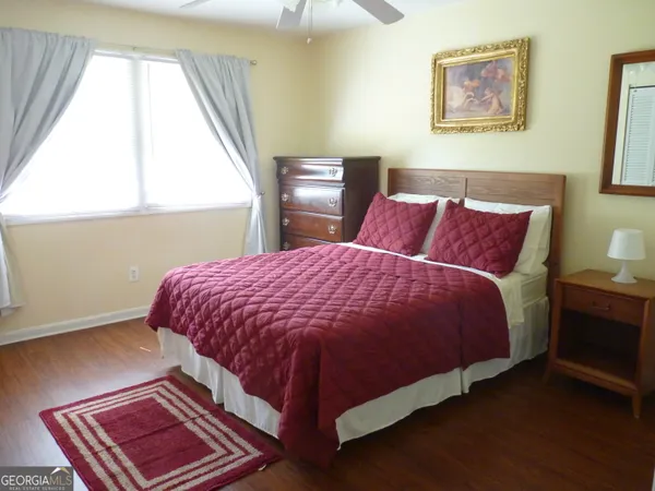 a bed sitting in a bedroom next to a window