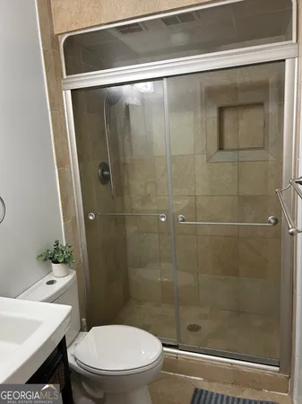 a bathroom with a shower and a toilet