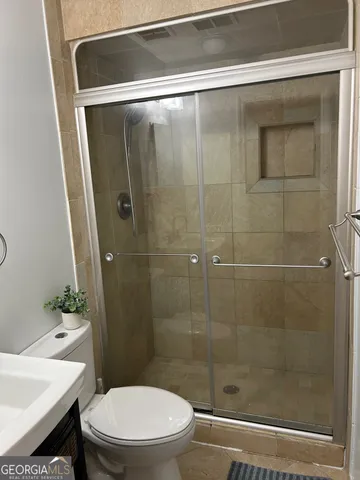 a bathroom with a shower and a toilet