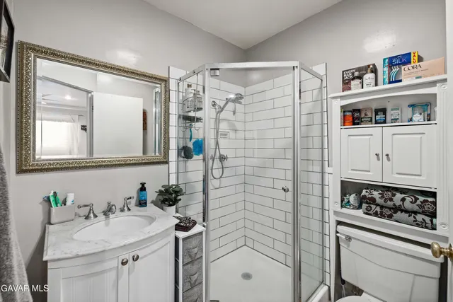 a bathroom with a sink a vanity and a mirror