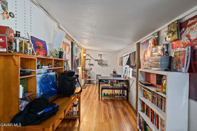 a living room with lots of furniture and a book shelf