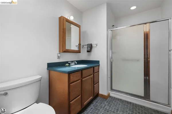 a bathroom with a stove a sink and a mirror
