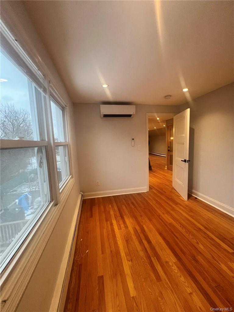36 Roanoke Avenue, Unit 2 Rye Brook, NY 10573 - Photo 13 of 15 a view of an empty room with wooden floor and a window