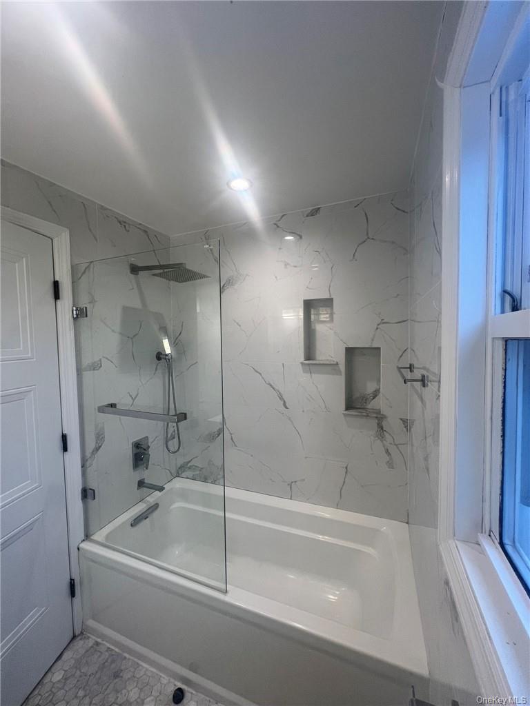36 Roanoke Avenue, Unit 2 Rye Brook, NY 10573 - Photo 15 of 15 a bathroom with a bathtub and a shower