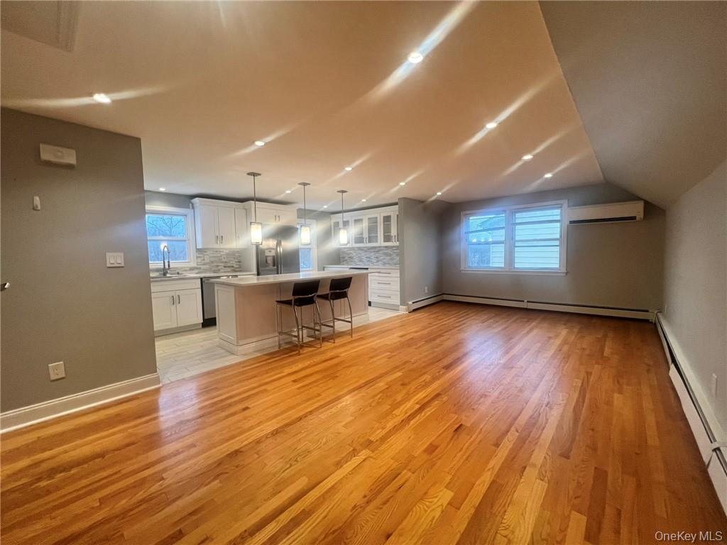 36 Roanoke Avenue, Unit 2 Rye Brook, NY 10573 - Photo 3 of 15 an empty room with wooden floor and windows