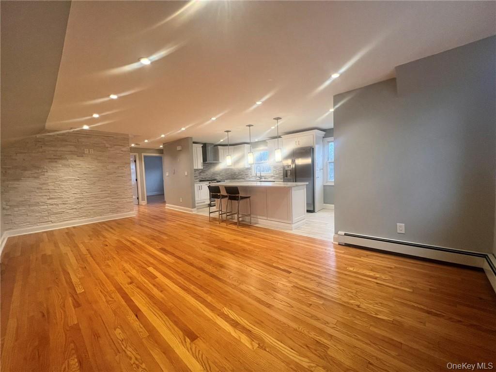 36 Roanoke Avenue, Unit 2 Rye Brook, NY 10573 - Photo 4 of 15 a view of kitchen and empty room with wooden floor