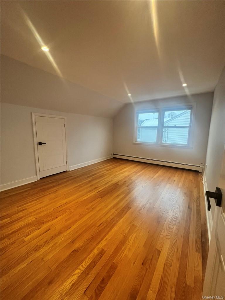 36 Roanoke Avenue, Unit 2 Rye Brook, NY 10573 - Photo 9 of 15 an empty room with wooden floor and windows