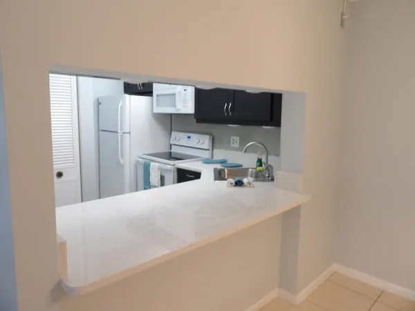 a kitchen with a sink a stove and cabinets