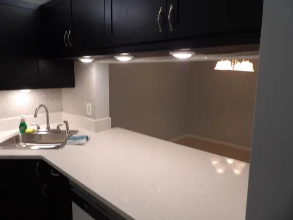 a white refrigerator freezer sitting inside of a kitchen
