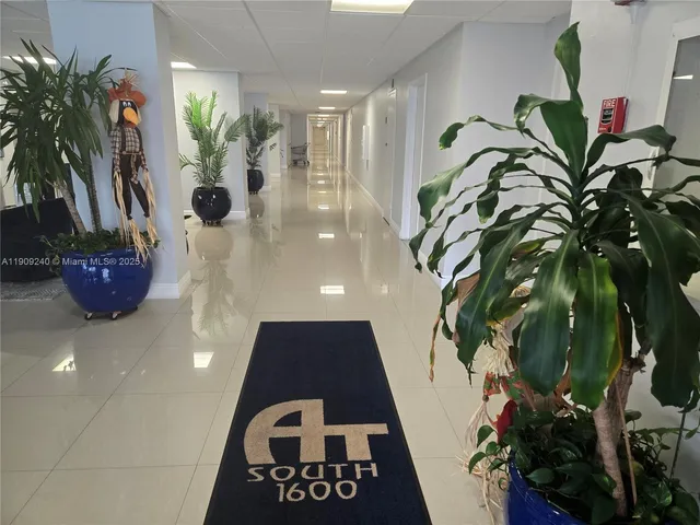 a kitchen with a refrigerator and a table
