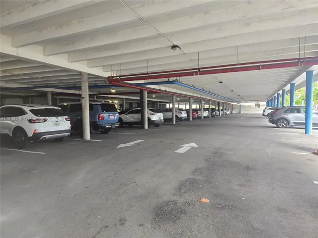 a view of parking garage with cars