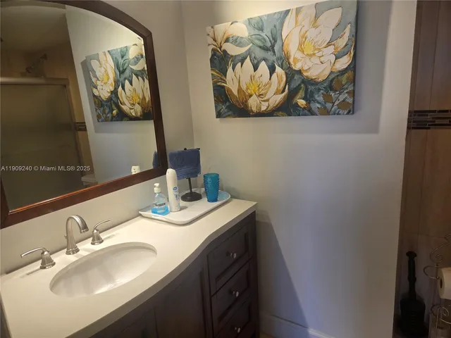 a white toilet sitting next to a shower