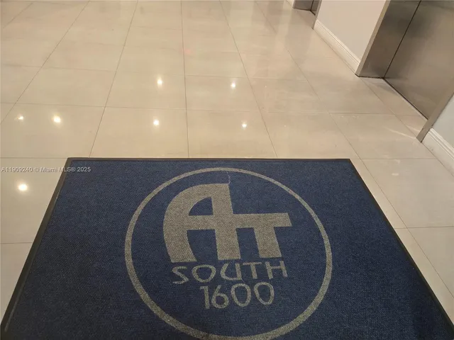 a lobby with furniture and a gym machine