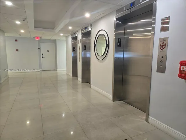a lobby with furniture and potted plants