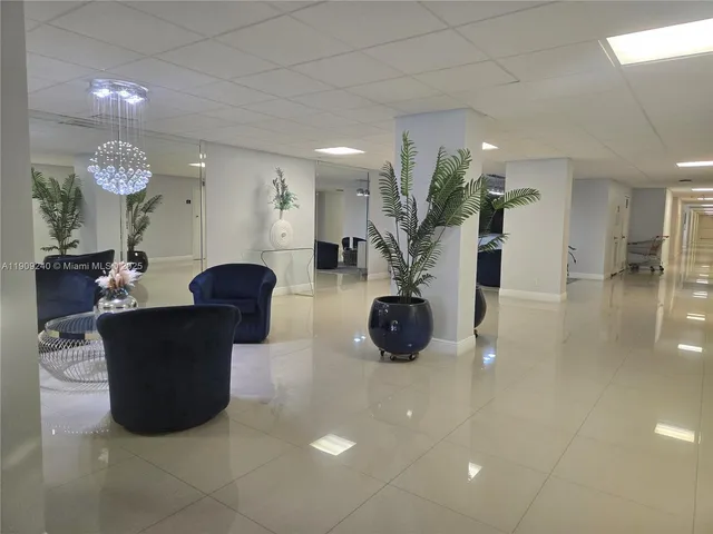 a vase of flowers sitting on a floor