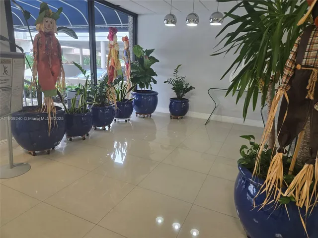 a view of a patio with table and chairs under an umbrella