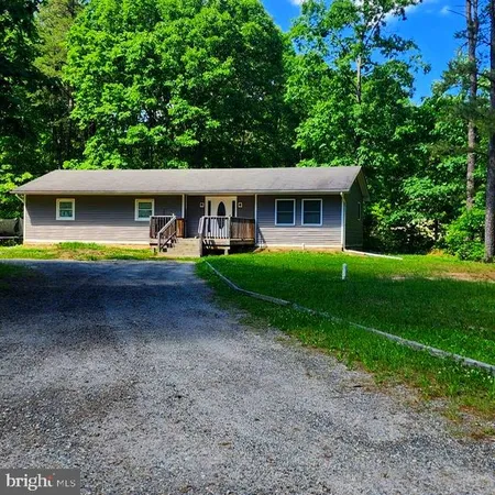 a view of a house with pool and a yard