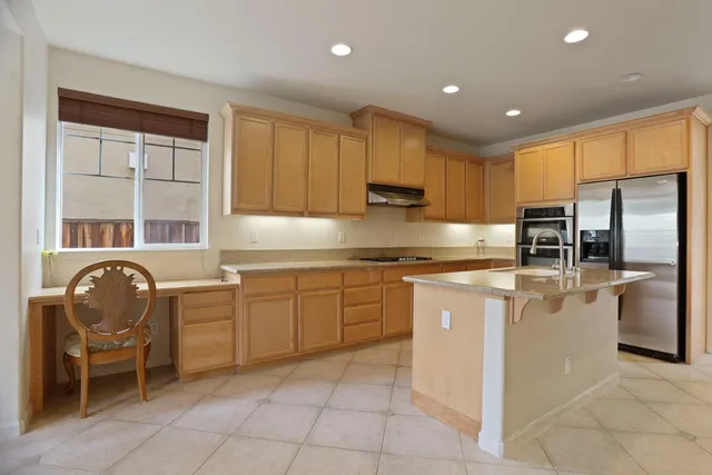 a kitchen with cabinets and window