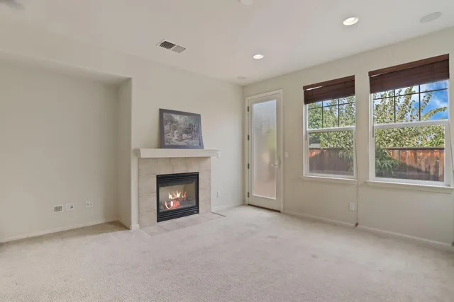a view of an empty room with a fireplace