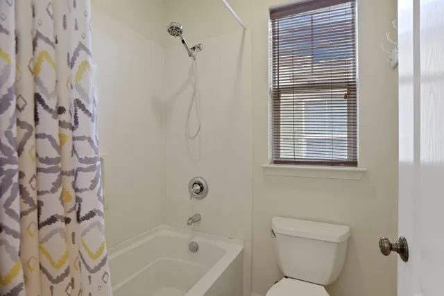 a bathroom with a toilet and a bathtub