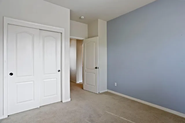 a view of an empty room and closet area