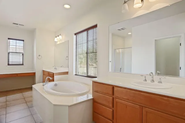 a bathroom with a sink double vanity and tub