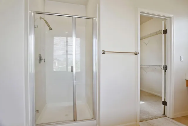 a bathroom with a glass shower door