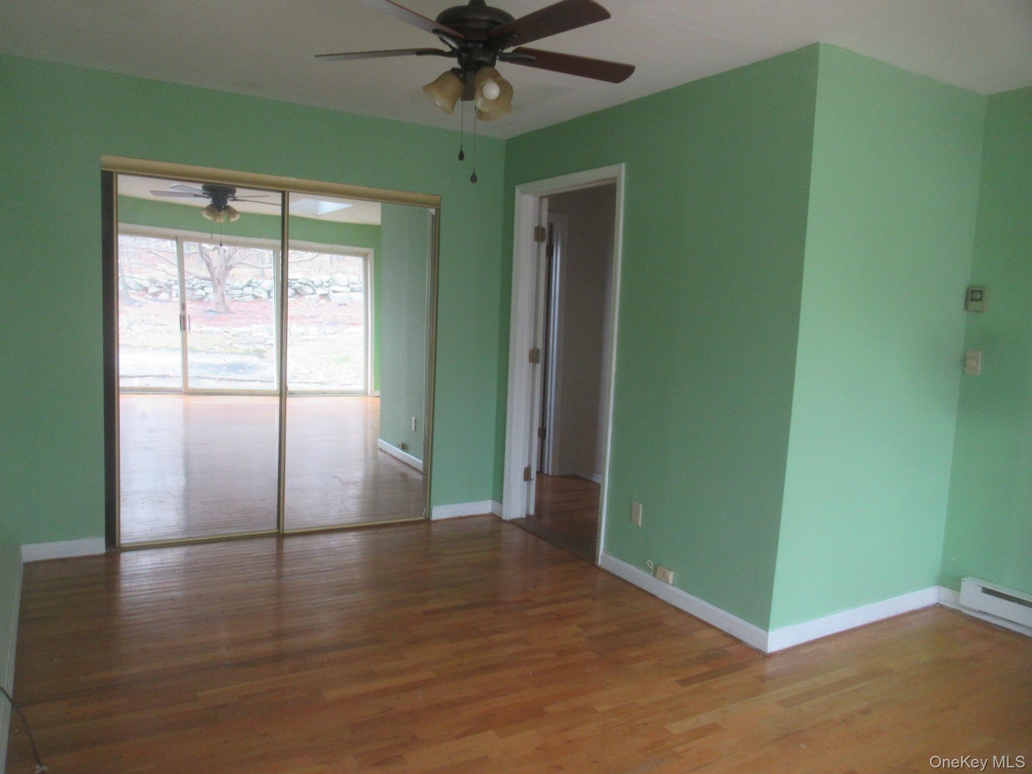64 Hillside View Road Mahopac, NY 10541 - Photo 12 of 23 Unfurnished room with wood finished floors and ceiling fan