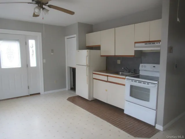 a kitchen with cabinets appliances and a window