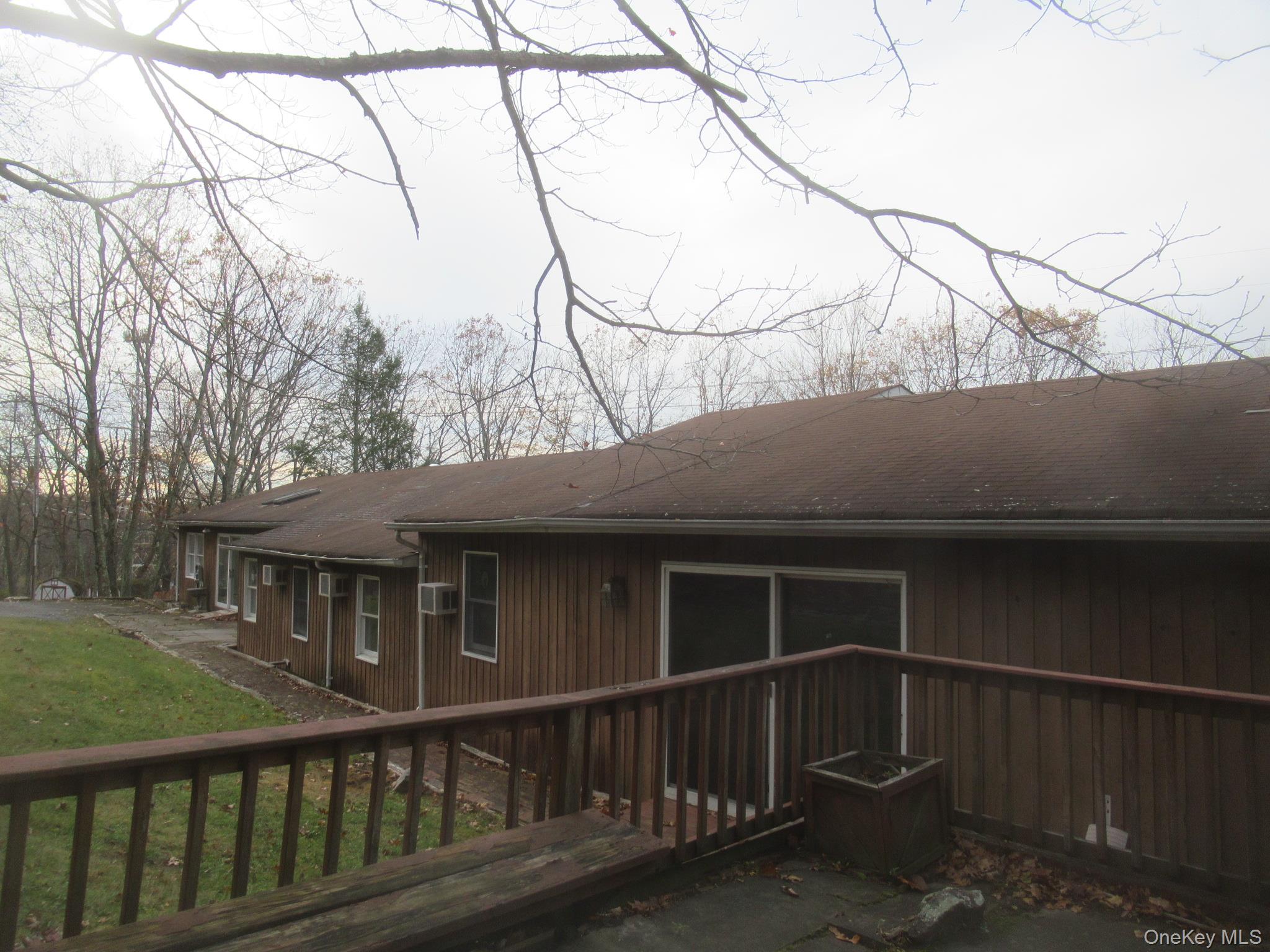 64 Hillside View Road Mahopac, NY 10541 - Photo 22 of 23 Back of house featuring a yard, a deck, and roof with shingles