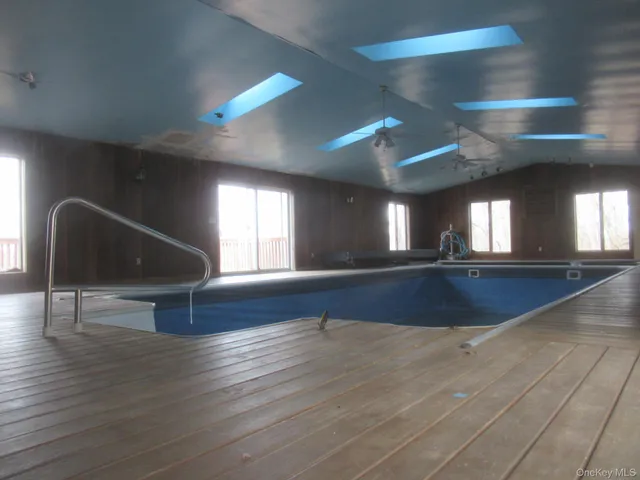 a view of room and hall with wooden floor