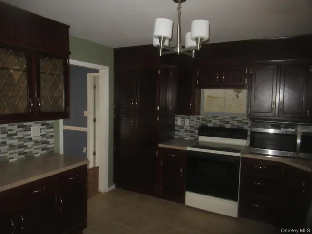 a kitchen with stainless steel appliances wooden cabinets and a sink