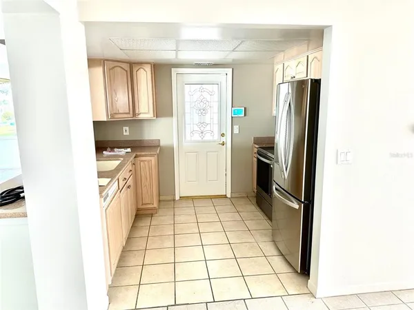 a kitchen with stainless steel appliances granite countertop a sink a stove and cabinets