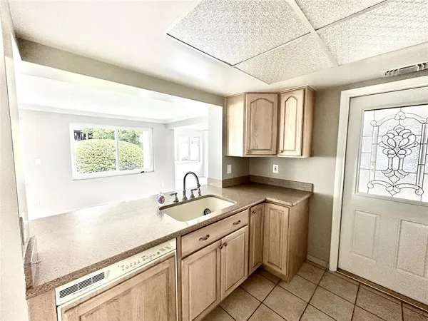 a kitchen with granite countertop a refrigerator stove top oven and sink