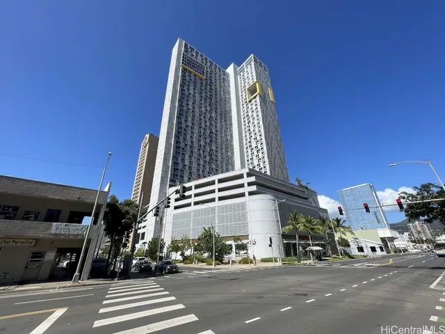 a view of a tall building next to a road