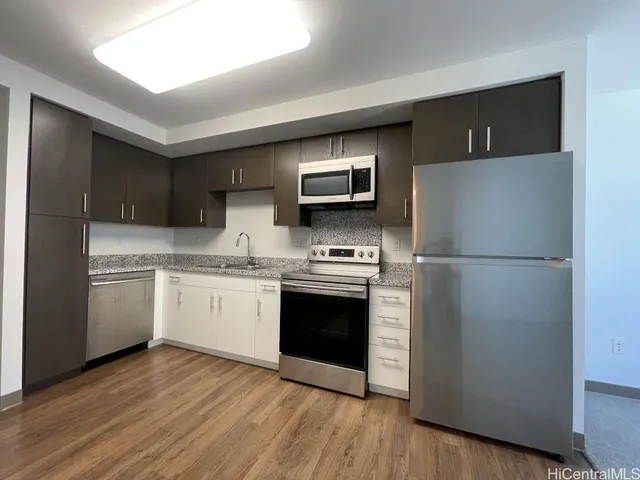 a kitchen with a refrigerator sink and microwave