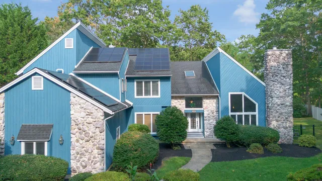 a aerial view of a house next to a yard