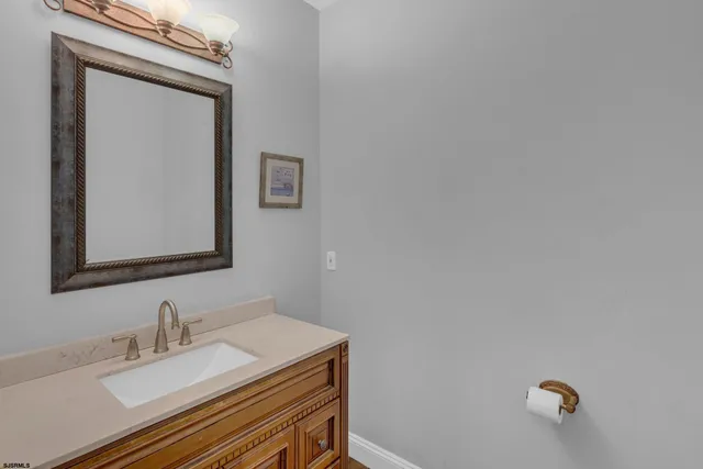 a bathroom with a sink vanity and a mirror