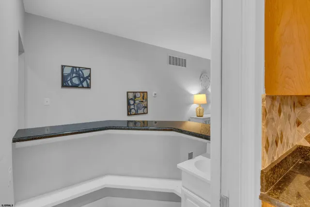 a view of a hallway with wooden floor and dining room