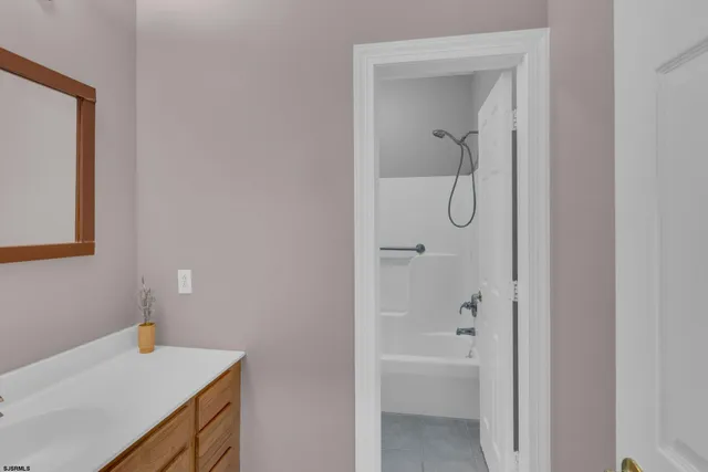 a bathroom with a granite countertop sink a mirror and vanity