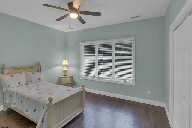 a bedroom with a bed couch and window