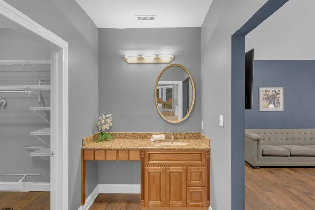 a view of a patio with table and chairs potted plants and large tree