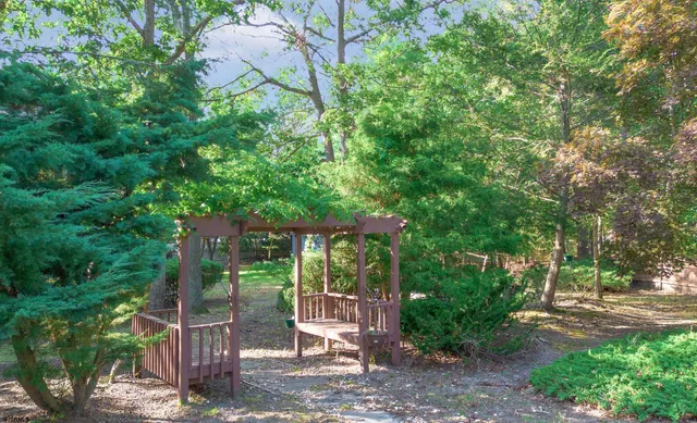 a view of a chair and table in backyard