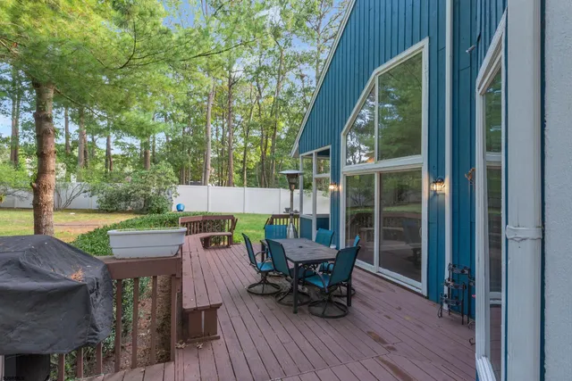 a view of a house with a yard and sitting area