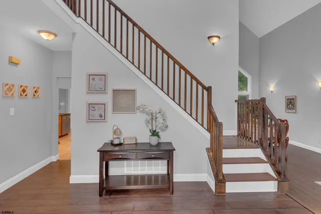 a view of entryway and hall with wooden floor
